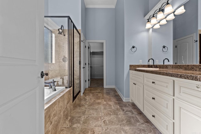 bathroom featuring plus walk in shower, vanity, and crown molding