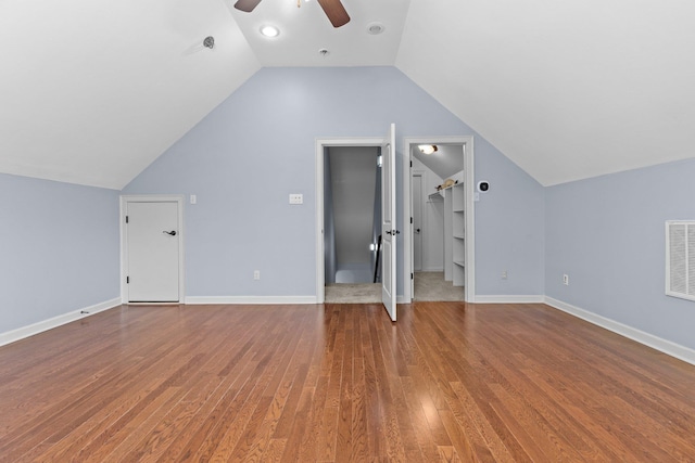 additional living space with built in shelves, ceiling fan, lofted ceiling, and hardwood / wood-style floors