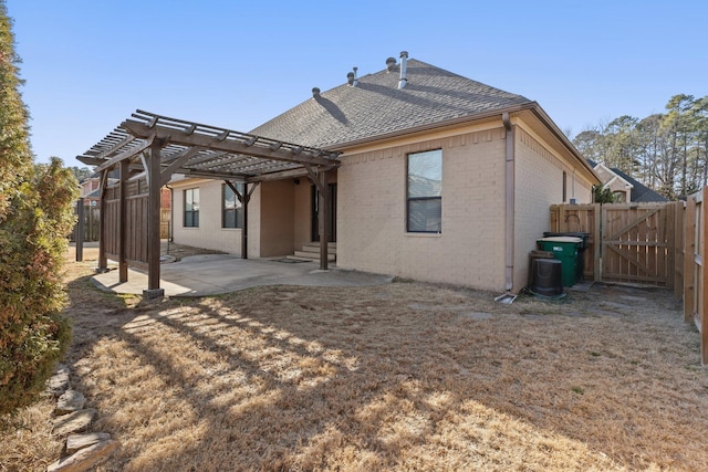 back of property featuring a pergola and a patio