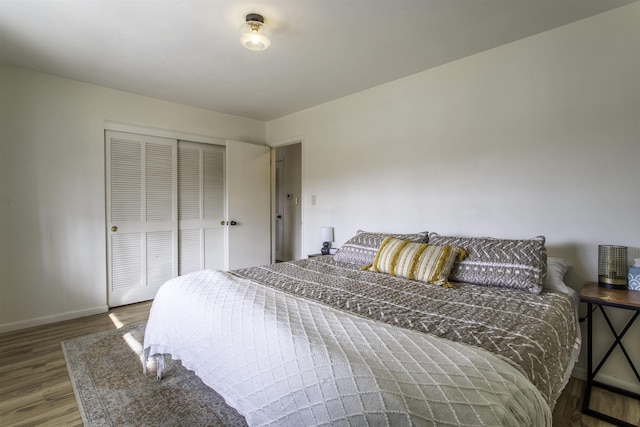 bedroom featuring hardwood / wood-style floors and a closet