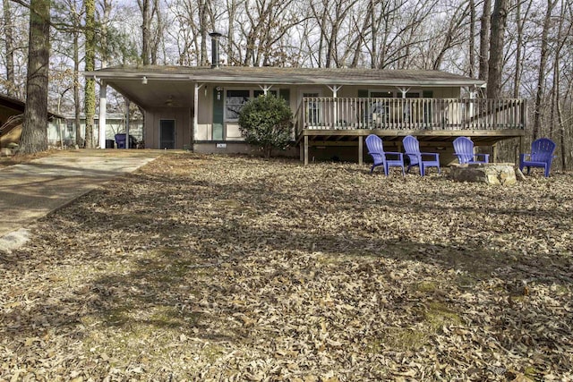 view of front facade with a wooden deck and a carport