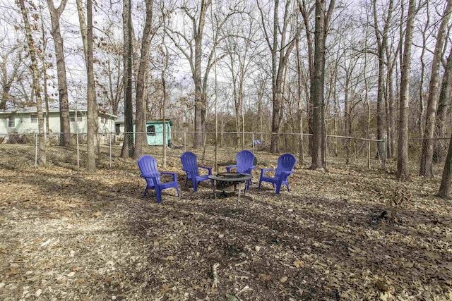 view of yard with a fire pit