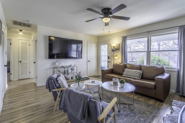 living room featuring wood-type flooring and ceiling fan