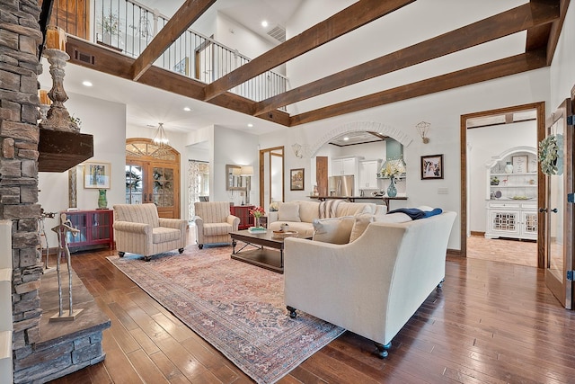 living room featuring dark wood-type flooring and a high ceiling