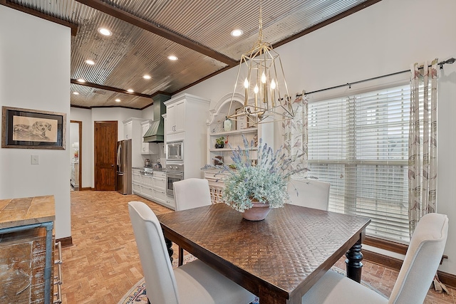 dining area with beam ceiling, a notable chandelier, wood ceiling, and ornamental molding