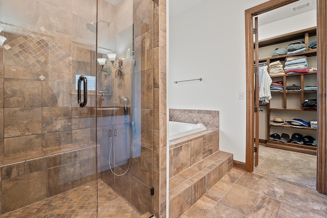 bathroom featuring independent shower and bath