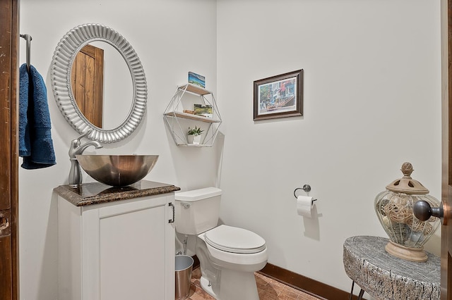 bathroom featuring hardwood / wood-style flooring, vanity, and toilet