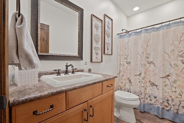 bathroom featuring vanity, hardwood / wood-style floors, toilet, and a shower with shower curtain