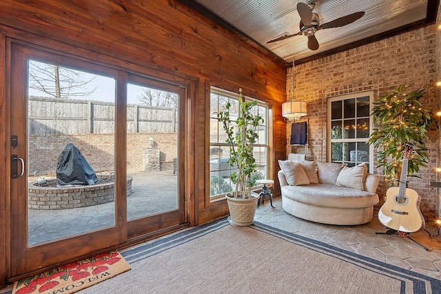 sunroom featuring a healthy amount of sunlight and ceiling fan