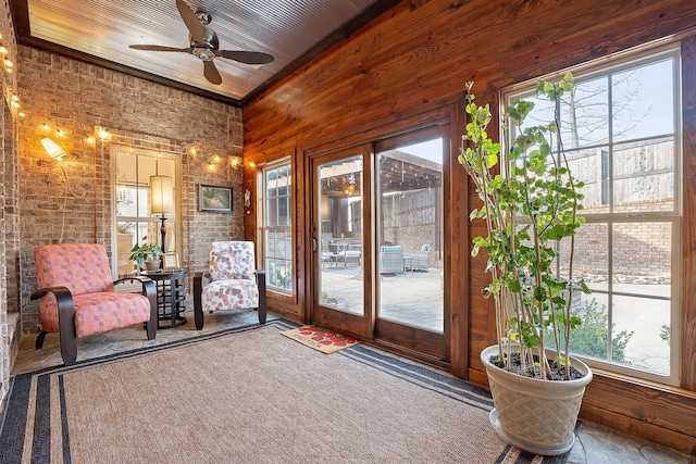 unfurnished sunroom featuring wood ceiling and ceiling fan