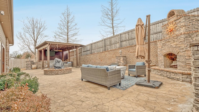 view of patio featuring an outdoor living space with a fireplace