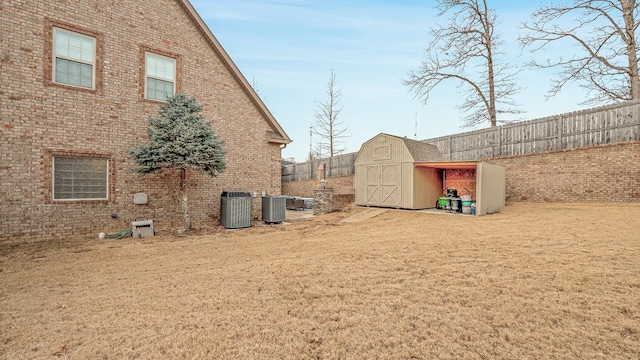 view of yard with cooling unit and a storage unit