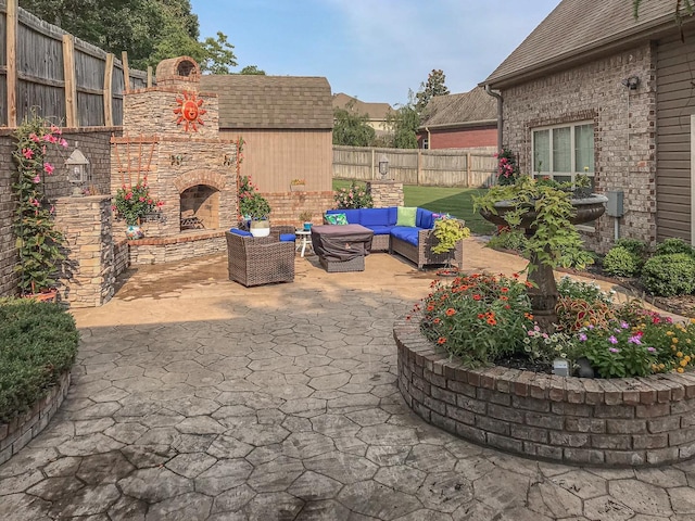 view of patio / terrace with an outdoor living space with a fireplace