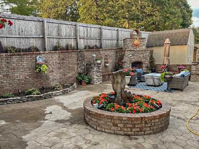 view of patio with exterior fireplace