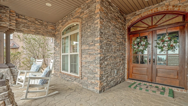 doorway to property featuring french doors and covered porch