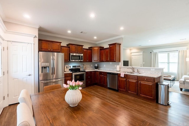 kitchen with sink, dark hardwood / wood-style floors, kitchen peninsula, stainless steel appliances, and light stone countertops