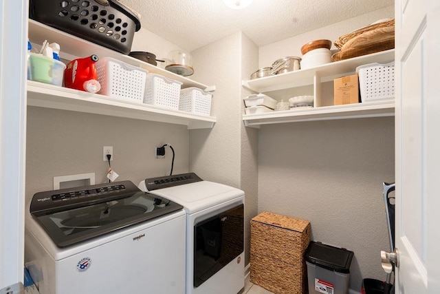 laundry area featuring washing machine and dryer and a textured ceiling