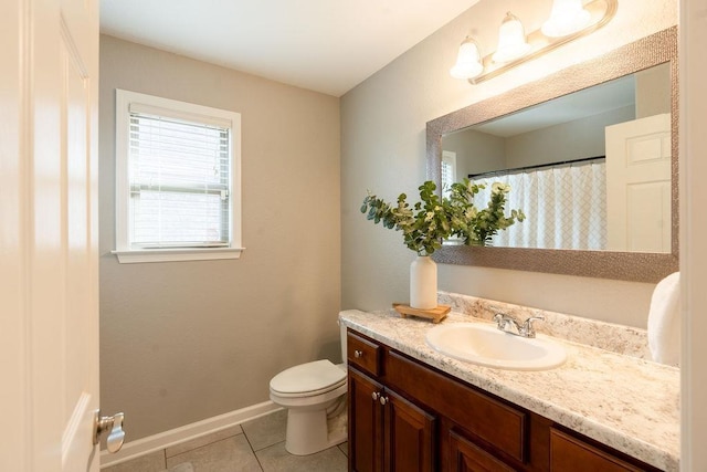 bathroom with vanity, toilet, and tile patterned flooring