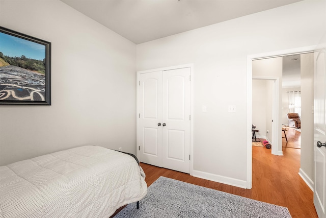 bedroom featuring light hardwood / wood-style floors and a closet