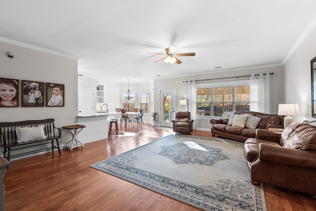 living room with crown molding, dark wood-type flooring, sink, and ceiling fan