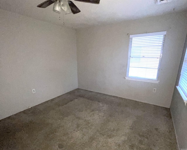 unfurnished room featuring ceiling fan and carpet flooring