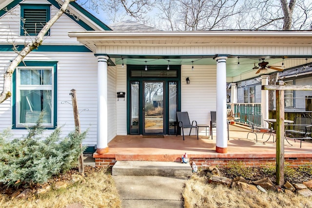 doorway to property featuring a porch and ceiling fan