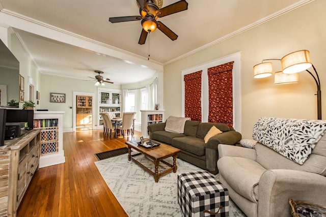 living room featuring crown molding, ceiling fan, and hardwood / wood-style floors