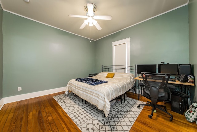 bedroom with ceiling fan, ornamental molding, and hardwood / wood-style floors