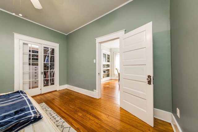 bedroom with crown molding, wood-type flooring, french doors, and ceiling fan