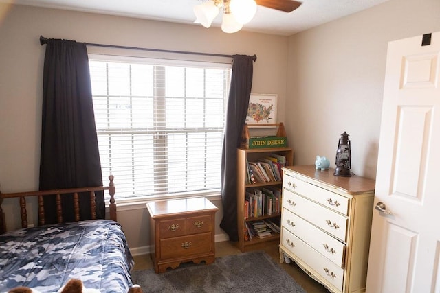 bedroom with ceiling fan and multiple windows