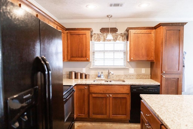 kitchen featuring pendant lighting, light stone countertops, sink, and black appliances