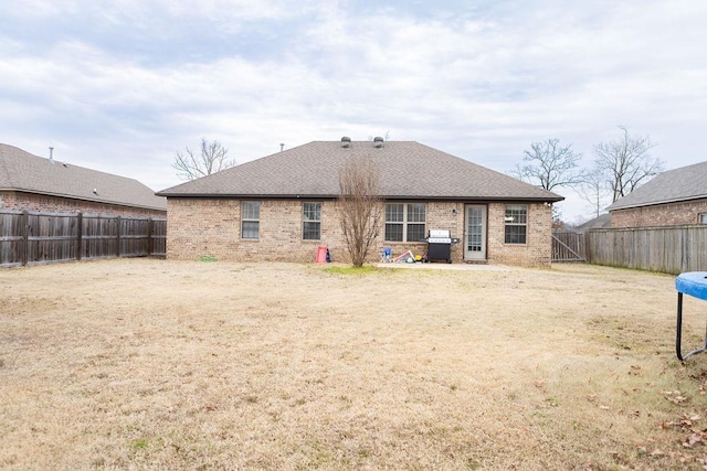 rear view of house featuring a lawn