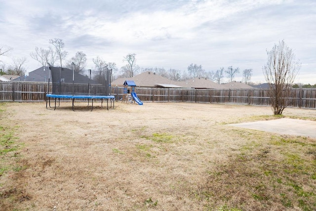 view of yard with a playground, a patio area, and a trampoline