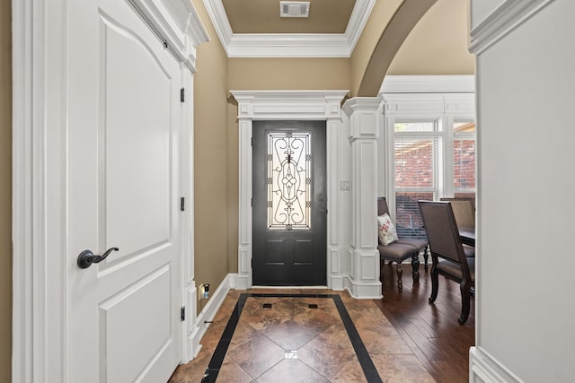 entrance foyer with decorative columns and ornamental molding