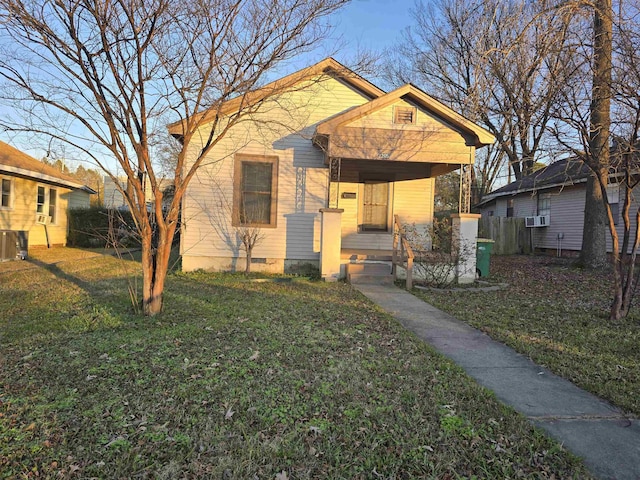 bungalow-style home with cooling unit and a front yard