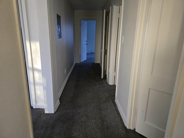 hall featuring dark colored carpet