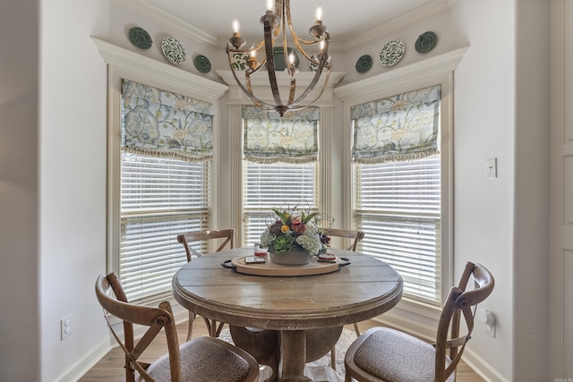 dining room with ornamental molding, wood-type flooring, and a chandelier