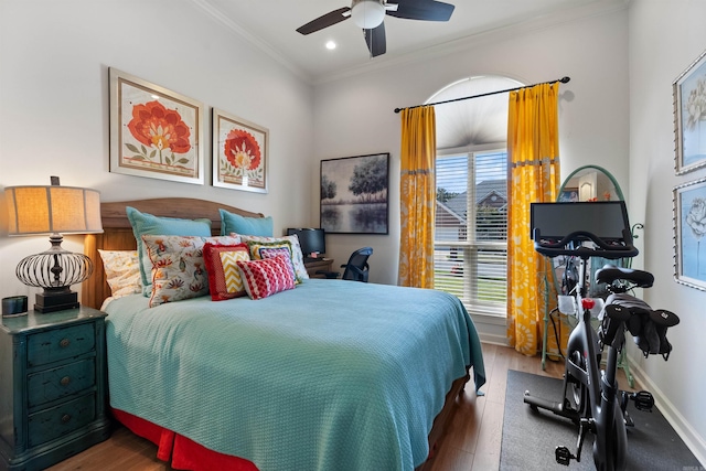 bedroom with crown molding, dark wood-type flooring, and ceiling fan