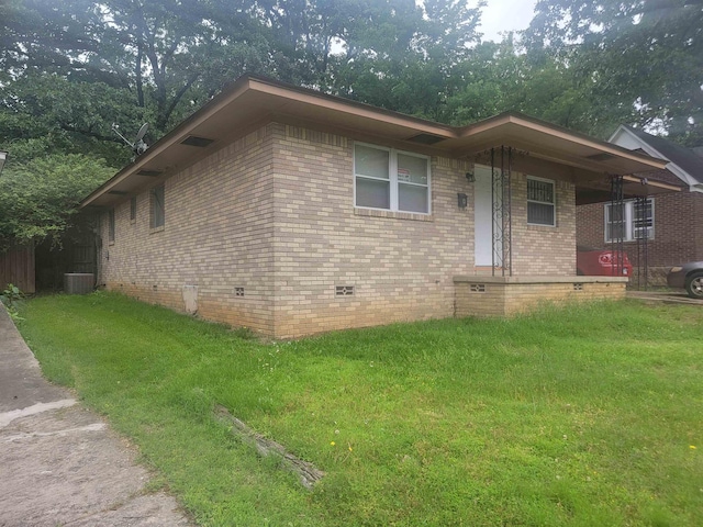 view of front of property with a front yard and central air condition unit