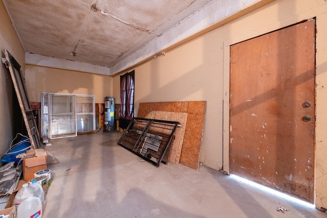 interior space featuring water heater and concrete floors