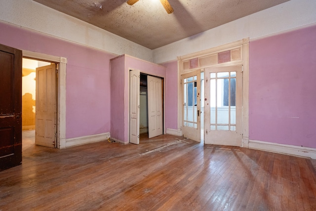 spare room featuring wood-type flooring and ceiling fan