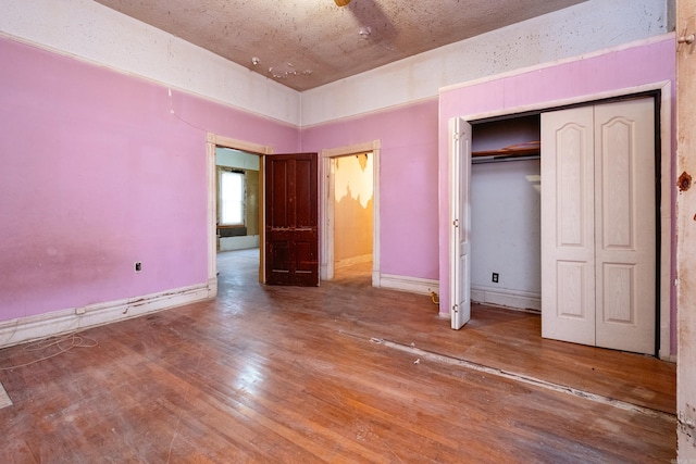 unfurnished bedroom featuring wood-type flooring and a closet