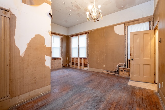 interior space with a chandelier and hardwood / wood-style floors