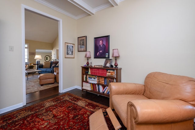 sitting room with beamed ceiling, crown molding, and dark hardwood / wood-style floors