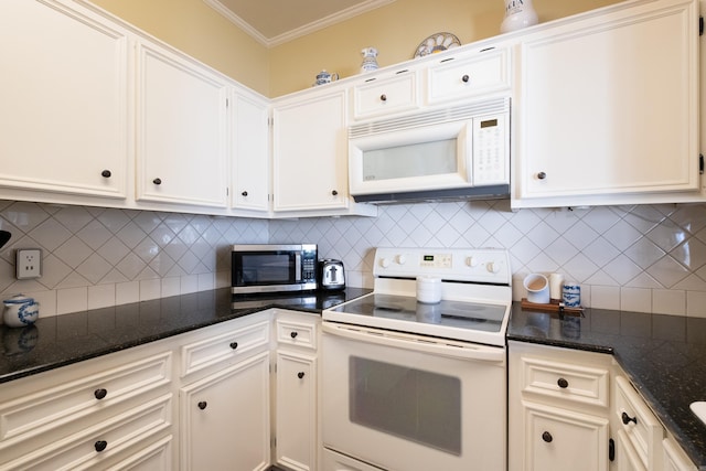 kitchen featuring dark stone countertops, white appliances, crown molding, and white cabinets