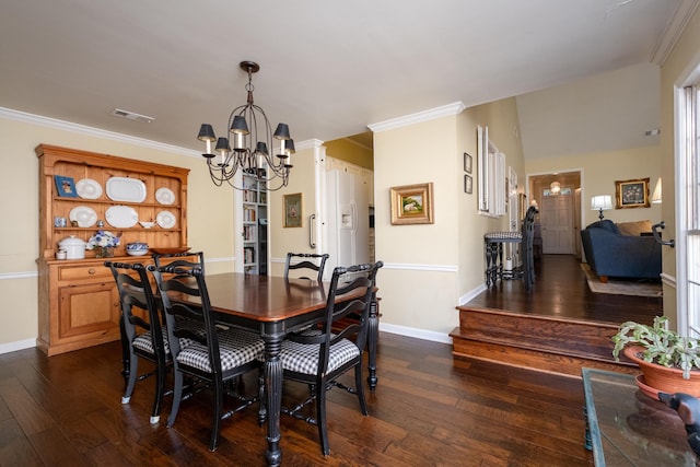 dining space featuring ornamental molding, dark hardwood / wood-style floors, and a chandelier