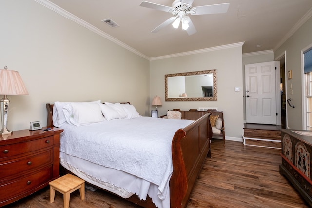 bedroom featuring dark hardwood / wood-style flooring, ornamental molding, and ceiling fan