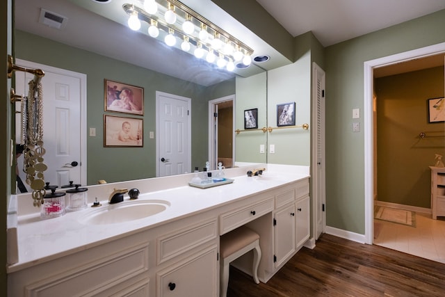 bathroom with hardwood / wood-style flooring and vanity