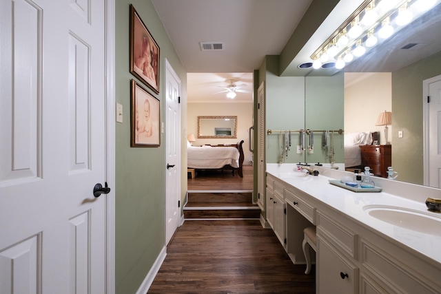 bathroom with vanity, wood-type flooring, ceiling fan, and ornamental molding