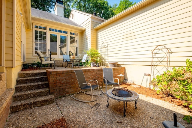 view of patio with french doors and an outdoor fire pit